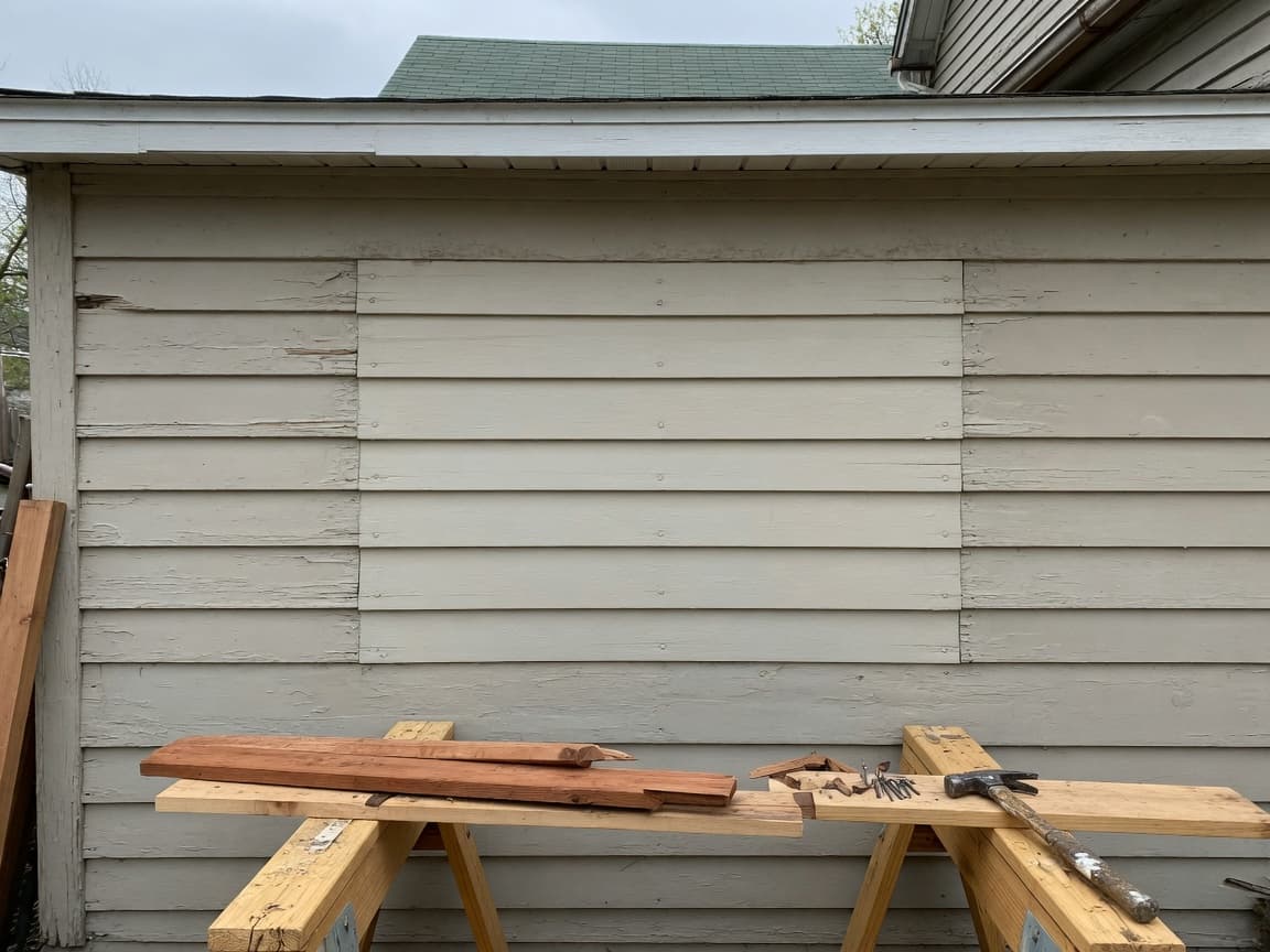 Repaired painted wood siding on a house exterior
